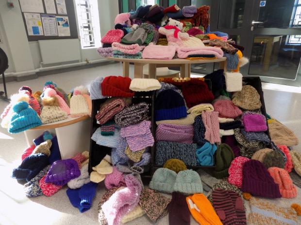 The image shows items knitted by Hydebank young offenders and female prisoners which have been donated to Salvation Army