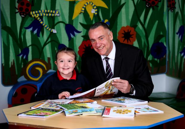 Pictured with the Fivemiletown Primary School pupil is David Kennedy, Governor of Maghaberry Prison.