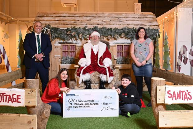 David Savage, Maghaberry Prison Deputy Governor, visited the National Autistic Society Santa’s Grotto at Newtownards to present a cheque for £5,185, proceeds of prisoners’ recycling and catering fundraising efforts. Included are Jasmine Savage, Trudi Kild